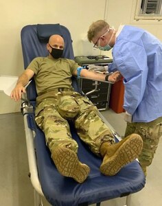 Spc. Riley Jackson administers a blood draw on Lt. Col. Marcus D. Perkins, commander of the U.S. Army Medical Materiel Center-Korea, during a field training exercise, held Aug. 10-14. The 95th Medical Detachment-Blood Support, a component of USAMMC-K, conducted the exercise to drill its prescreening procedures and practice operations for a large-scale blood collection event.