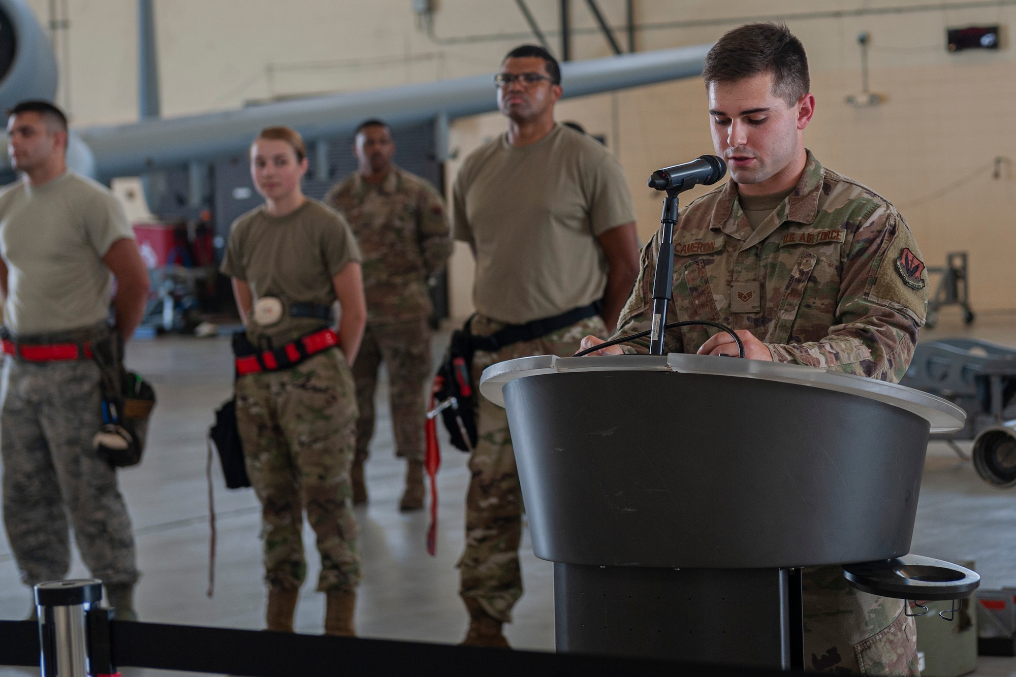 Photo of an Airman speaking at a weapons load competition