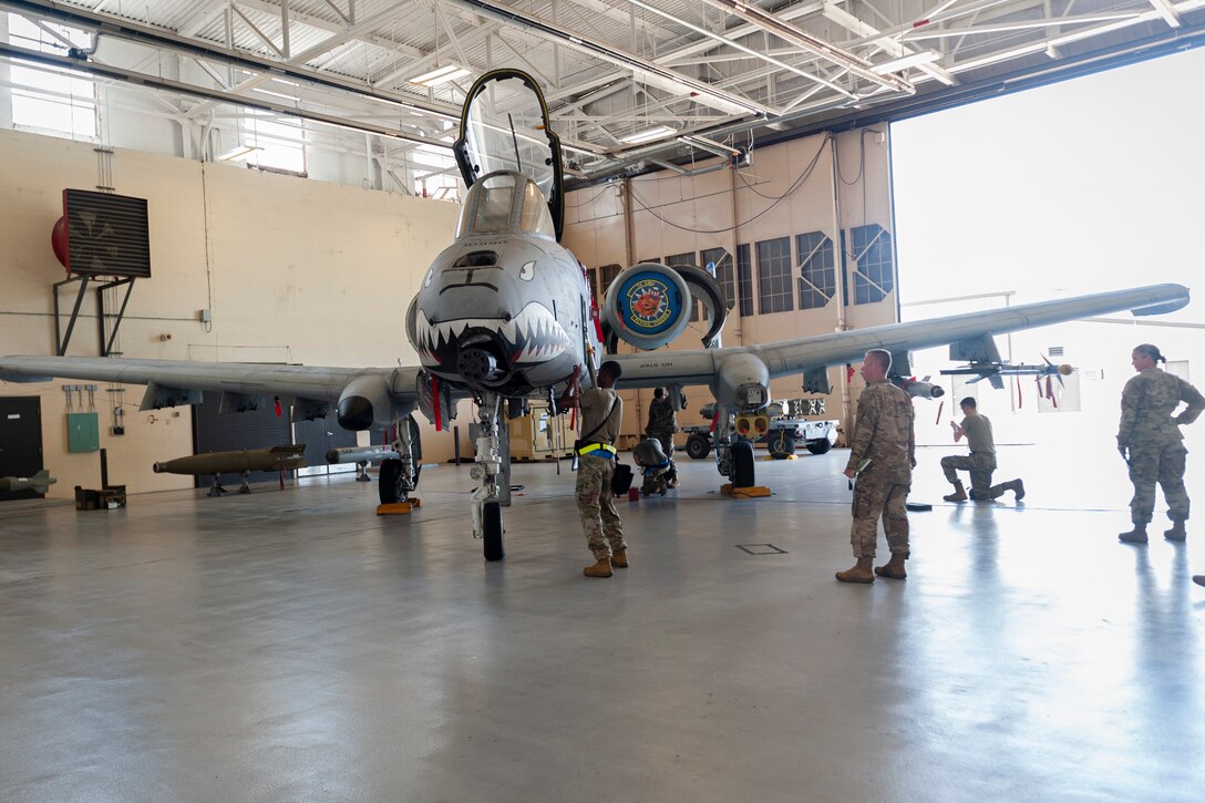 Photo of Airmen participating in a weapons load competition