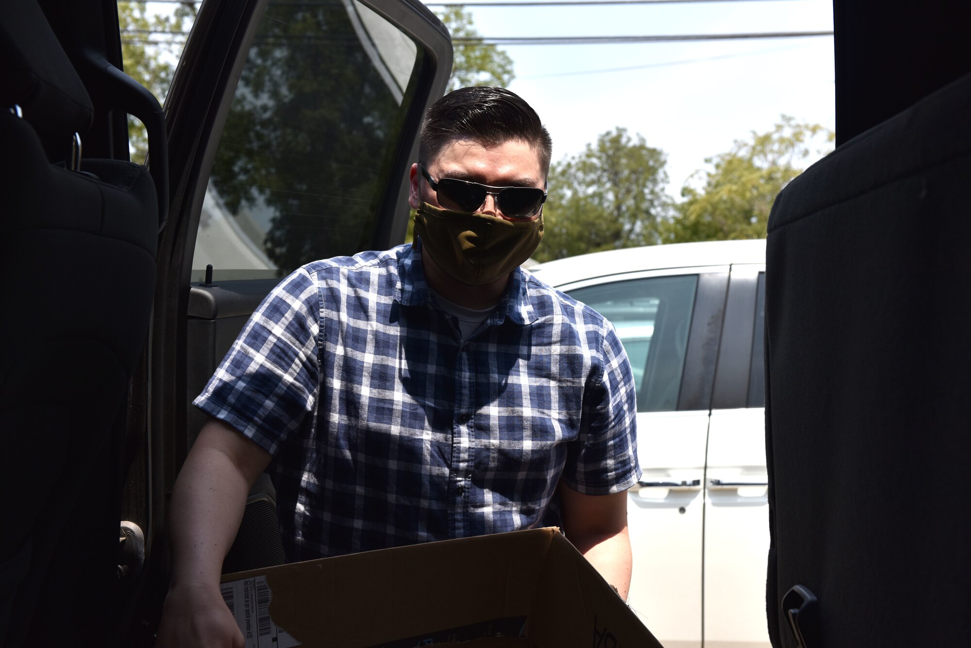 Volunteer John Ogami, unloads a box from a truck during the donation drop off at the Concho Valley Home For Girls in San Angelo, Texas, Aug. 21, 2020. Volunteers practiced COVID-19 health precautions while unloading over five hundred dollars’ worth of donations for the home. (U.S. Air Force photo by Staff Sgt. Seraiah Wolf)