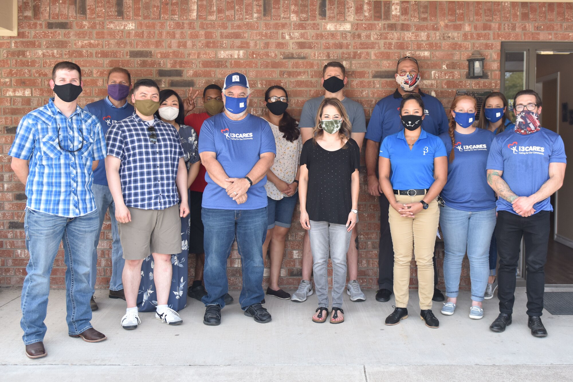 Goodfellow volunteers and the Concho Valley Home for Girls staff gather for a photo outside of the organization's headquarters in San Angelo, Texas, Aug. 21, 2020. The staff and volunteers followed COVID-19 health precautions while unloading supplies from vehicles. (U.S. Air Force photo by Staff Sgt. Seraiah Wolf)