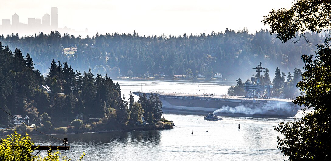 The USS Carl Vinson (CVN 70) makes its way past Point Herron Aug. 23, 2020 after departing Puget Sound Naval Shipyard & Intermediate Maintenance Facility in Bremerton, Washington. PSNS & IMF completed a docking planned incremental availability on Vinson Aug. 27, 2020, as the aircraft carrier completed sea trials enroute to San Diego, where it was homeported prior to its arrival at Naval Base Kitsap-Bremerton, Jan. 20, 2019.(PSNS & IMF photo by Scott Hansen)