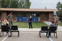 Brandi Hoff, True North Program Manager, cuts the ribbon to symbolize the opening of the new Welcome Center facility.  The 5th Bomb Wing held a ribbon-cutting ceremony to introduce a new Welcome Center facility August 21, 2020 at Minot Air Force Base, North Dakota.