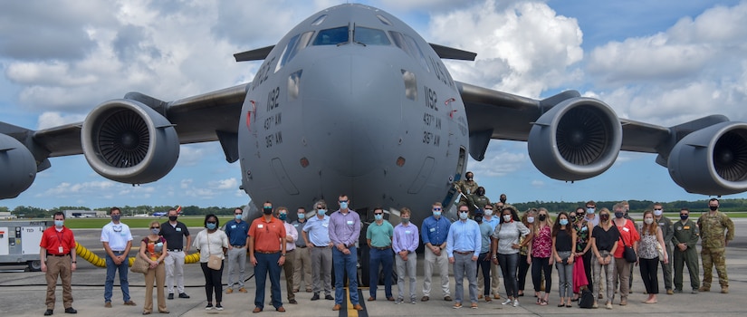Members assigned to the 315th Airlift Squadron and 18th Airlift Squadron, line up around a C-17 Globemaster III as part of a Charleston Leadership Tour at Joint Base Charleston, S.C., Aug 20, 2020. Members of Charleston organizations such as the Charleston Metro Chamber, encourage strengthening relationships between the community and military to support service members and their families, expanding the federal footprint in the region.
