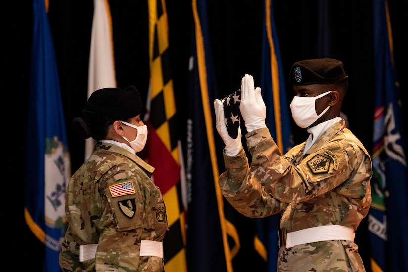 A Soldier inspects the U.S. flag during the relinquishment-of-command and retirement ceremonies in honor of Maj. Gen. Steven W. Ainsworth, the outgoing commander of the 84th Training Command, Aug. 22, 2020, at Fort Knox, Ky.