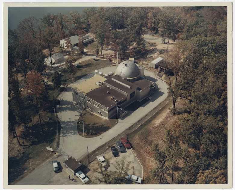 Aerial view of the former SM-1 nuclear power plant on Fort Belvoir in the 1960s. The facility provided limited power to Fort Belvoir and served as a training facility before being deactivated in 1973. SM-1 was partially decommissioned from 1973 into 1974, which consisted of the removal of the majority of the site’s radioactivity. This included the removal of nuclear fuel and control rods, minor decontamination, shipment of radioactive waste, sealing of the reactor pressure vessel, and installing appropriate warning signs and monitoring devices. The U.S. Army Corps of Engineers awarded a contract August 27, 2020 for the final decommissioning, dismantling and disposal of the facility.