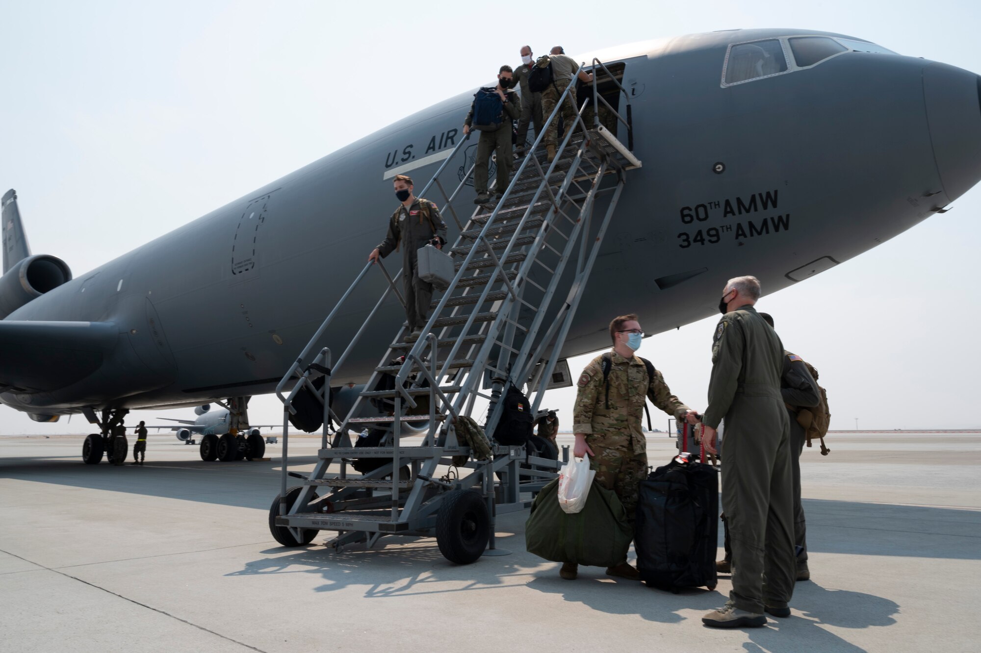 U.S. Airmen assigned to the 9th Air Refueling Squadron, exit a KC-10 Extender at Travis Air Force Base, California, Aug. 22, 2020.