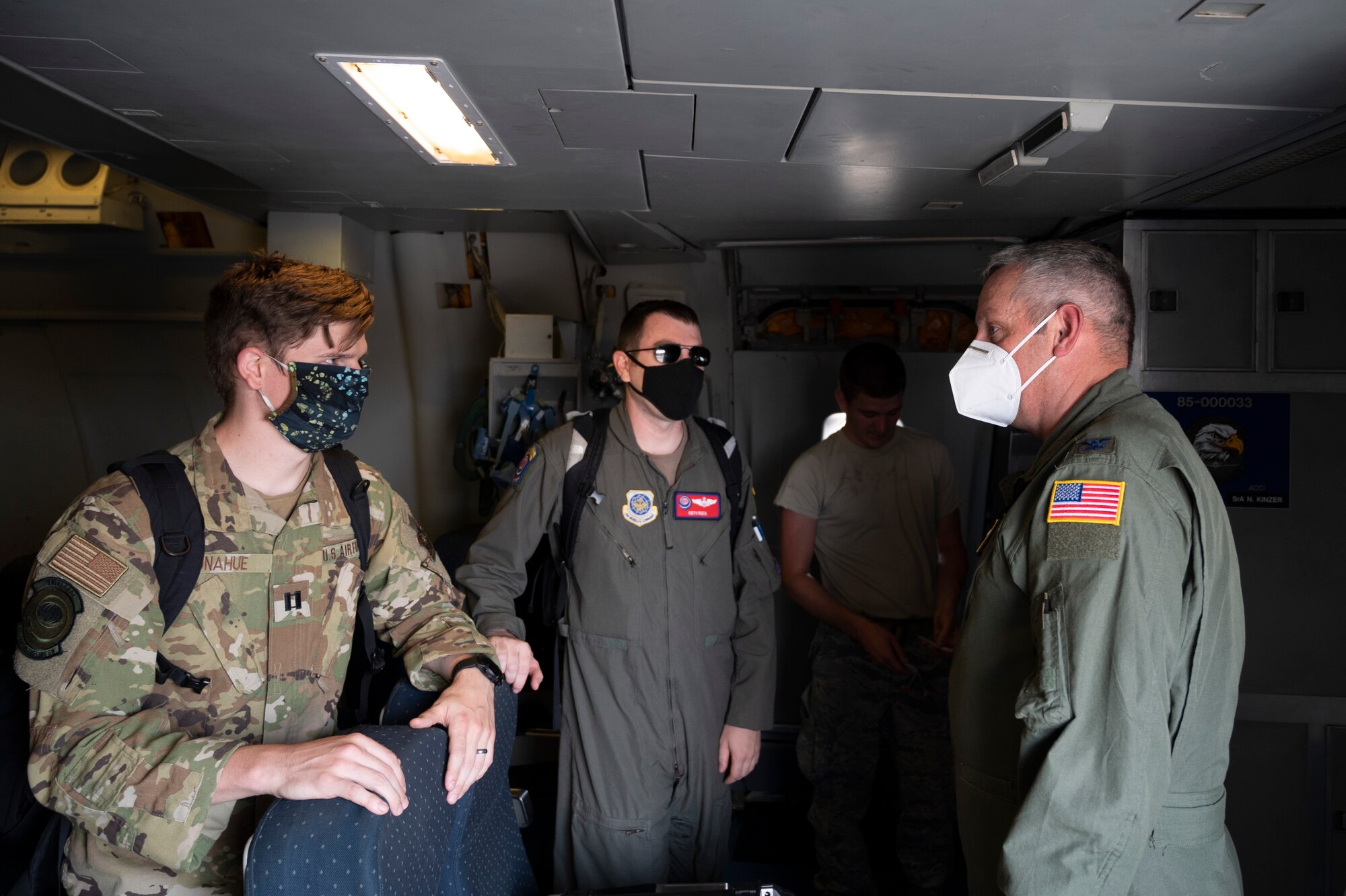 U.S. Air Force Col. Corey Simmons, 60th Air Mobility Wing commander, right, greets Capt. Cody Donahue, left, 9th Air Refueling Squadron KC-10 Extender pilot, and Maj. Keith Rizza, 9th ARS chief of standardization and evaluations, inside a KC-10.