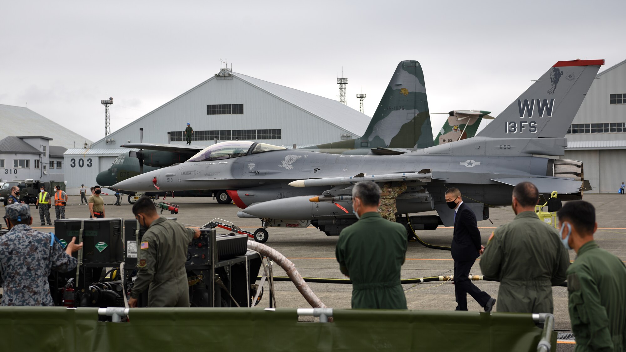 Individuals obverse refueling on an aircraft