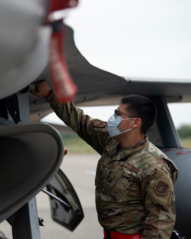 An individual inspects and aircraft