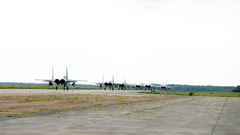 Individuals observe training in an outdoor environment