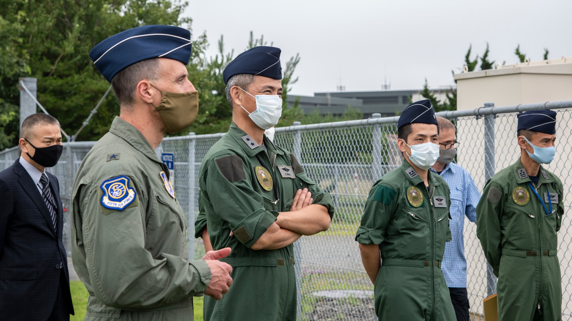 Individuals in uniform receive briefings from other individuals in uniform.