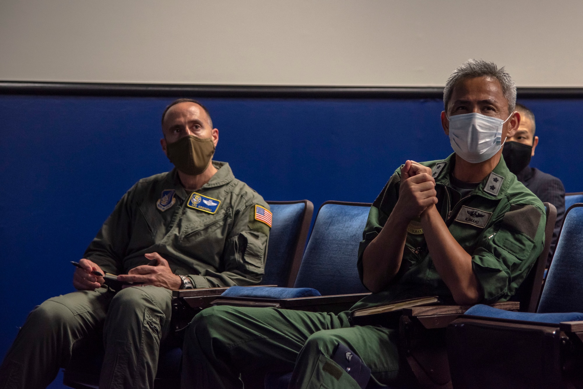 Individuals in uniform receive briefings from other individuals in uniform.