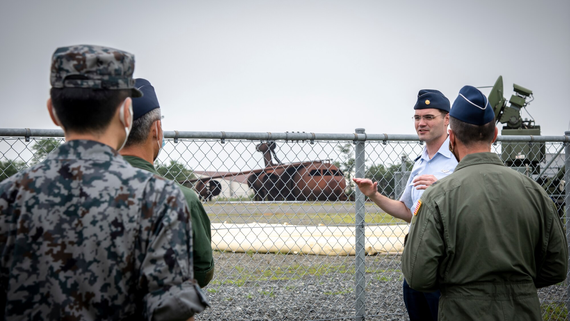 Individuals in uniform receive briefings from other individuals in uniform.