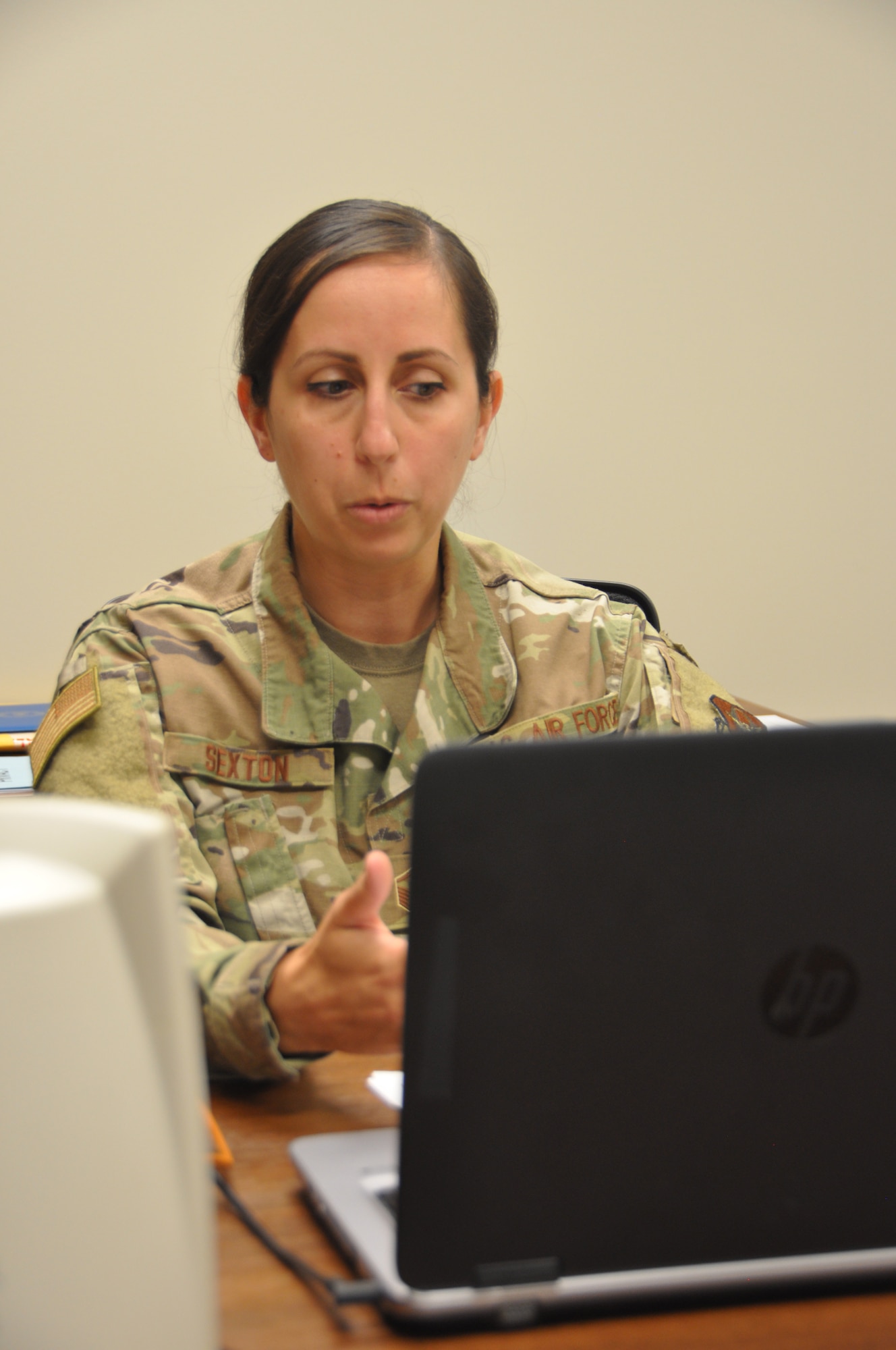 a person conducts a virtual class looking at a computer