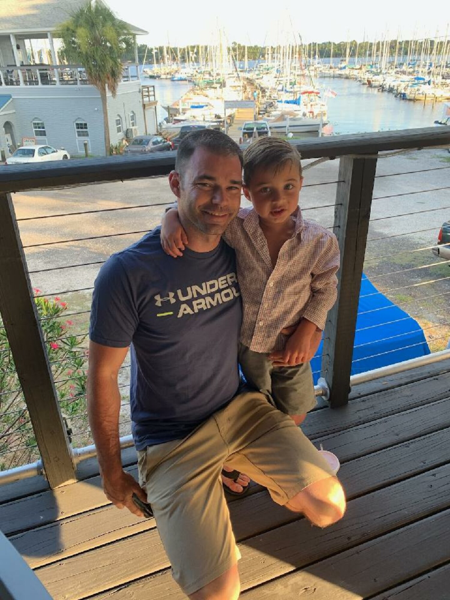 Photo of Master Sgt. Rotroff posing for a photo with his son by the water.