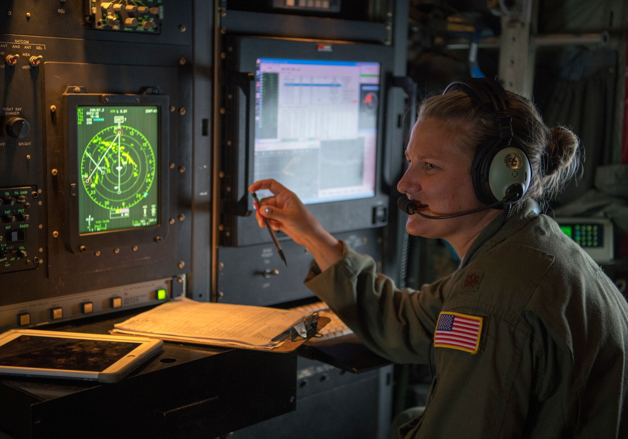 Maj. Kimberly Spusta, aerial reconnaissance weather officer for the 53rd Weather Reconnaissance Squadron, talks with the loadmaster across from her during a flight into Hurricane Laura from Charleston International Airport, S.C. Aug. 26, 2020. The 53rd WRS operates out of Keesler Air Force Base, Miss., and plays an important role in the forecasting of tropical systems by flying directly into storms and collecting atmospheric data satellites cannot reach, improving the area of impact by up to 25 percent. (U.S. Air Force photo by Senior Airman Kristen Pittman)