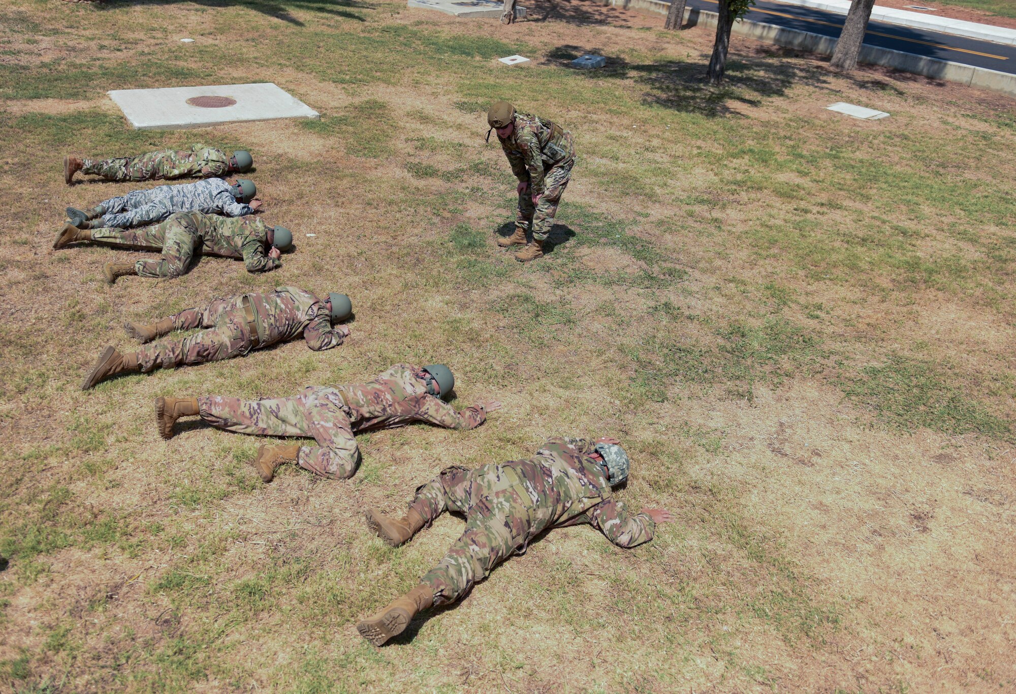 Airmen laying in prone position outside