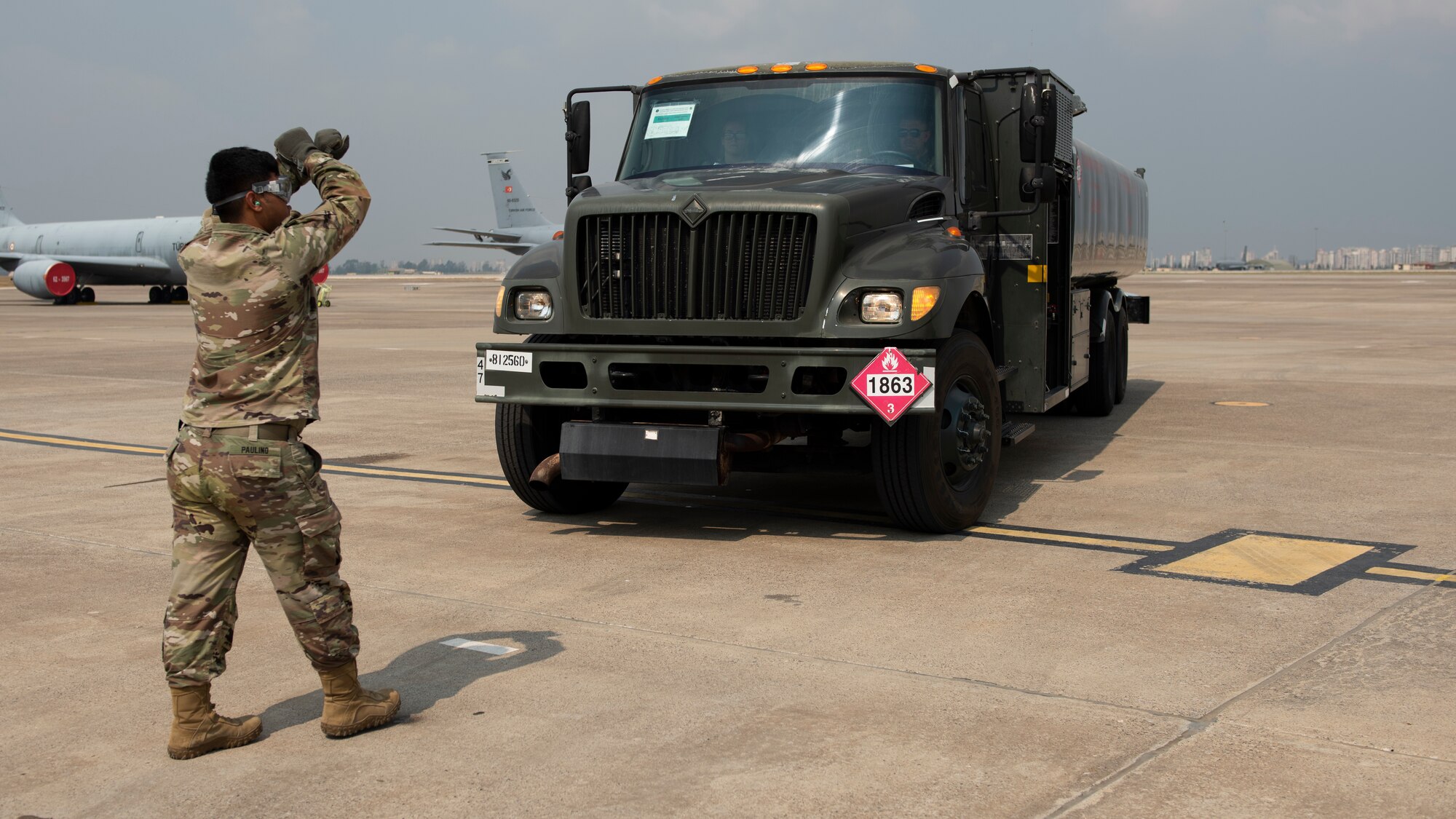 Airman stopping a fuel truck with hand signals