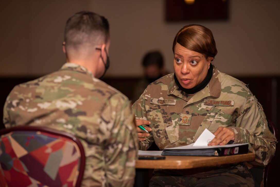 Chief Master Sgt. Audrea Hunt, 100th Logistics Readiness Squadron chief enlisted manager, provides guidance to a technical sergeant during a mentorship and records review board at Royal Air Force Mildenhall, England, Aug. 26, 2020. The Team Mildenhall Top III council organized the event to help technical sergeants learn what traits the master sergeant promotion board is seeking in senior noncommissioned officers. (U.S. Air Force photo by Airman 1st Class Joseph Barron)