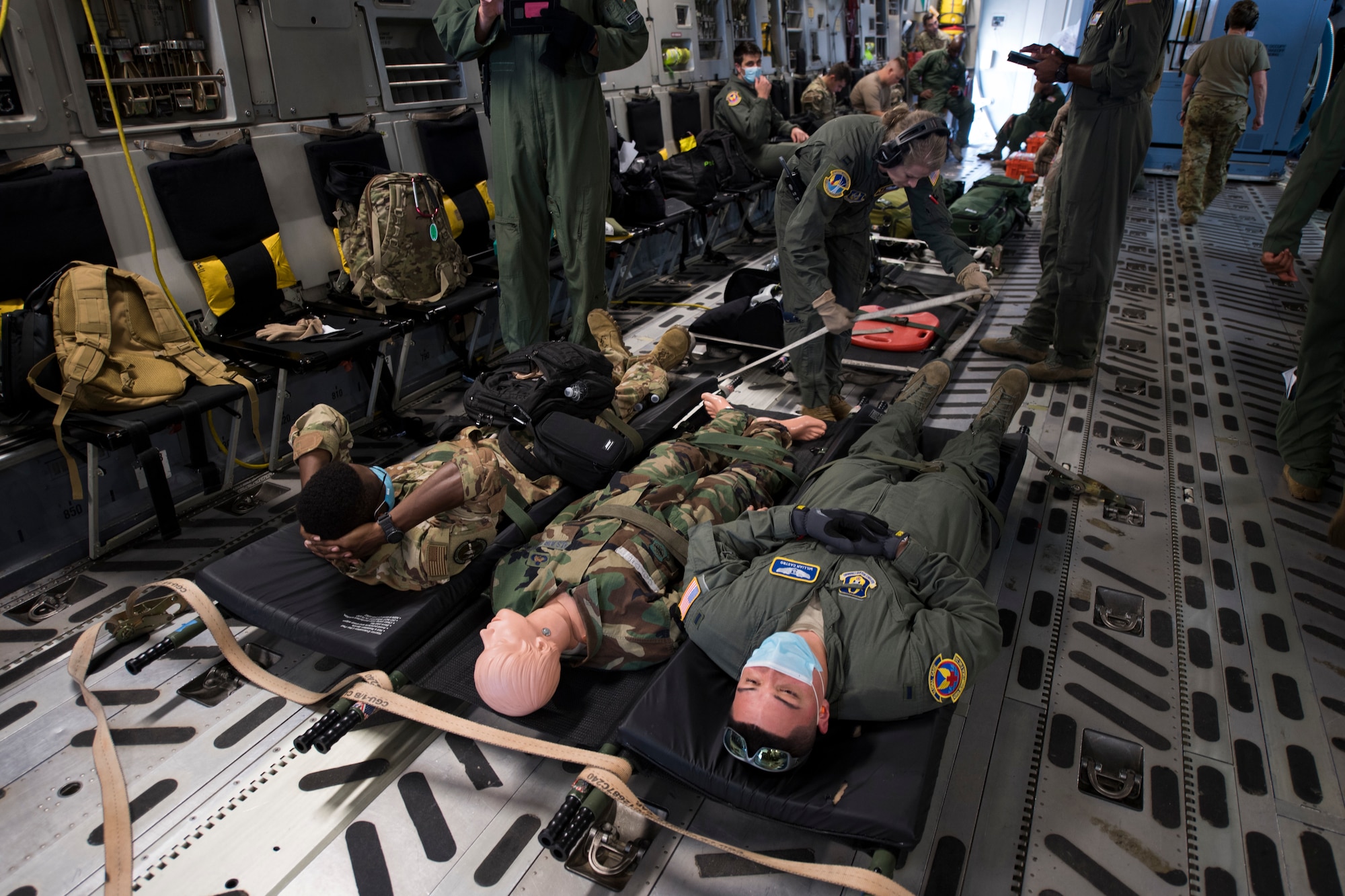 Members of the 908th Aeromedical Evacuation Squadron (AES), Maxwell AFB, Ala., and the 45th AES, provide care to simulated patients aboard a C-17 Globemaster III aircraft assigned to the 512th Airlift Wing, Dover AFB during a training exercise at MacDill Air Force Base, Fla., Aug. 21, 2020.