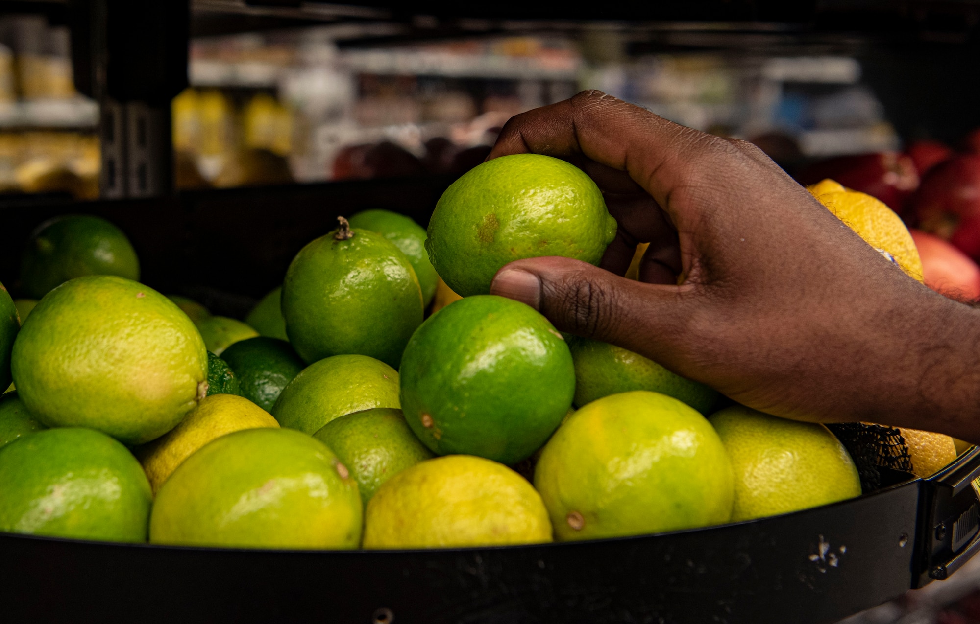 Photo of a sailor picking up a lime.