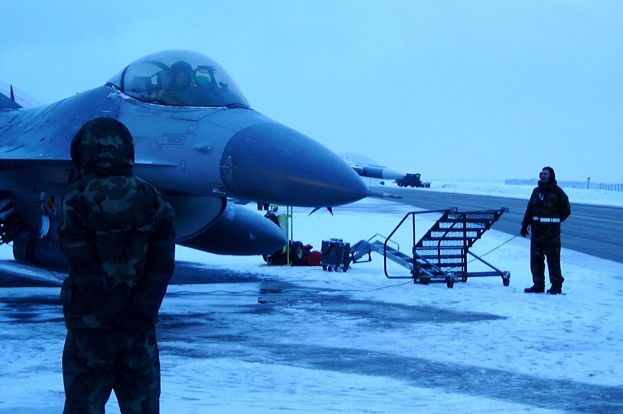 Airmen from the 388th prepare an F-16C sitting alert at an isolated part of Hill AFB for an ONE sortie during the Olympics in February 2002.