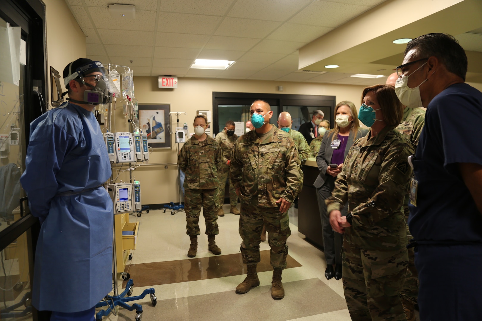 Medical personnel speaking with military personnel in a medical center.