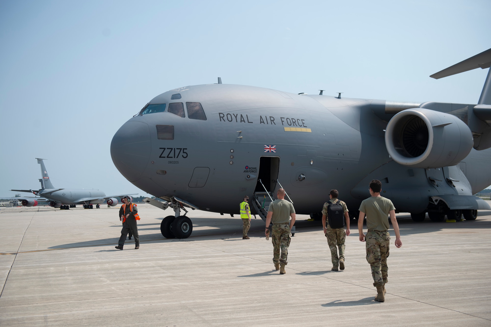 Grissom Airmen walk towards a Royal Air Force C-17 Globemaster III at Grissom Air Reserve Base, Indiana on Aug. 25, 2020. The Royal Air Force stopped at Grissom to train with the 49th Aerial Port Squadron on building cargo pallets. (U.S. Air Force photo/Senior Airman Michael Hunsaker)