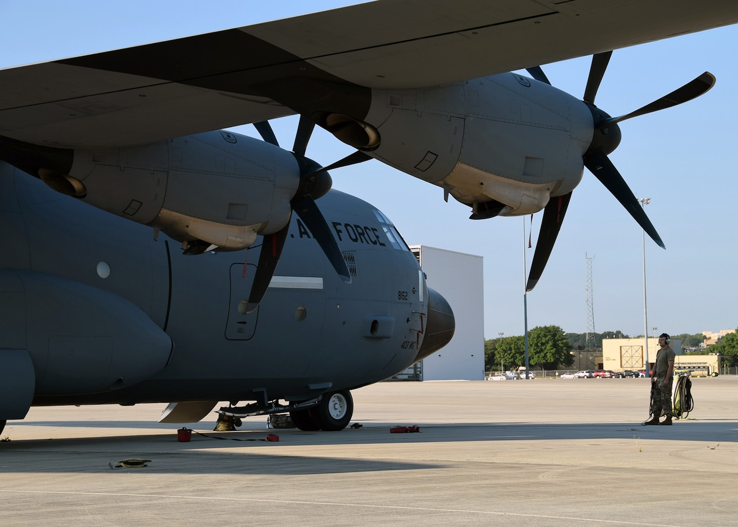 Staff Sgt. Zachary Faith, 403rd Aircraft Maintenance Squadron crew chief, performs a pre-flight check on a C-130J Hercules cargo aircraft Aug. 25 at Joint Base San Antonio-Lackland. Eight C-130Js evacuated from Keesler Air Force Base, Mississippi, to avoid damage from Hurricane Marco and Tropical Storm Laura.