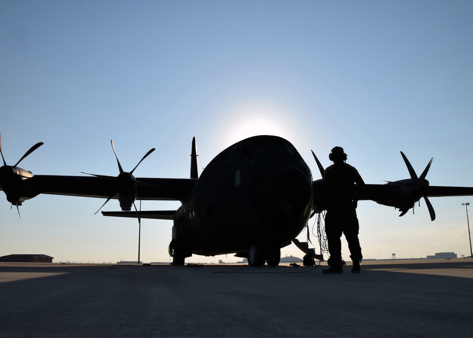 Staff Sgt. Zachary Faith, 403rd Aircraft Maintenance Squadron crew chief, performs a pre-flight check on a C-130J Hercules cargo aircraft Aug. 25 at Joint Base San Antonio-Lackland. Eight C-130Js evacuated from Keesler Air Force Base, Mississippi, to avoid damage from Hurricane Marco and Tropical Storm Laura.