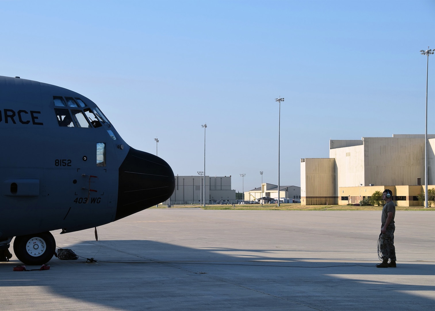 Staff Sgt. Zachary Faith, 403rd Aircraft Maintenance Squadron crew chief, performs a pre-flight check on a C-130J Hercules cargo aircraft Aug. 25 at Joint Base San Antonio-Lackland. Eight C-130Js evacuated from Keesler Air Force Base, Mississippi, to avoid damage from Hurricane Marco and Tropical Storm Laura.