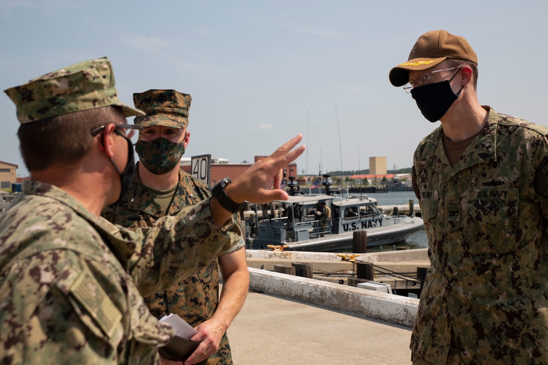 U.S. Marine Corps Brig. Gen. William E. Souza III, Deputy Commander of Marine Forces Reserve and Marine Forces North, middle, speaks to Rear Adm. Joseph A. DiGurando, perspective Commander of the Navy Expeditionary Combat Command, left, and Capt. David M. Rowland, Commander of Coastal Riverine Group Two, right, (NECC), Aug. 27, 2020, on Joint Base Little Creek in Virginia Beach, Virginia. The event familiarized Marine Corps leadership with U.S. Navy capabilities, and provided insight on the mission of Naval Expeditionary Combat Command. (U.S. Marine Corps photo by Sgt. Desmond Martin/released)