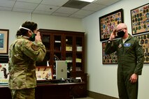 A photo of an officer saluting a general.