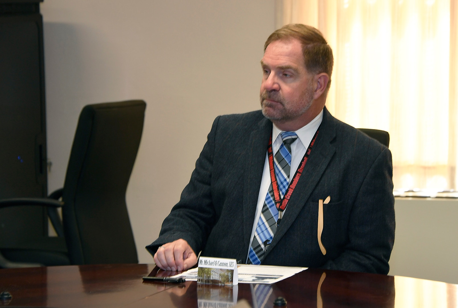 DLA Disposition Services Director Mike Cannon sits at a  conference table.