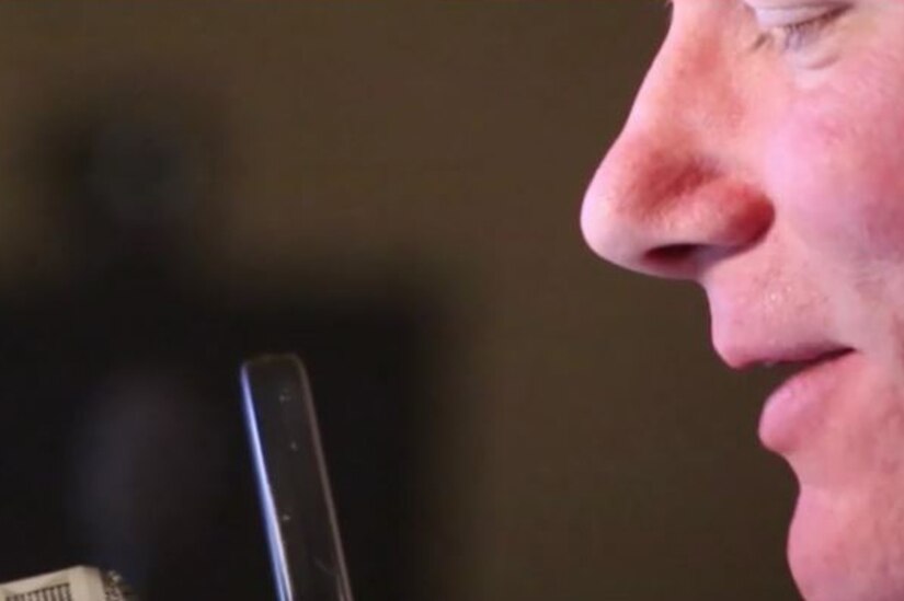 A Marine speaks into a microphone.