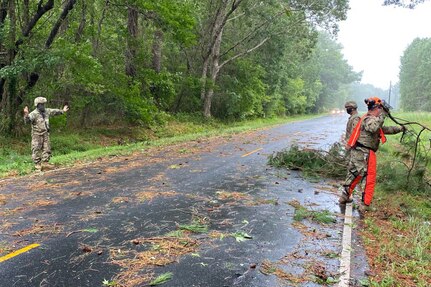 Virginia National Guard Soldiers assigned to the Norfolk-based 1st Battalion, 111th Field Artillery, 116th Infantry Brigade Combat Team, help clear a road of fallen trees and keep traffic moving after Tropical Storm Isaias Aug. 4, 2020, in Onancock, Virginia.