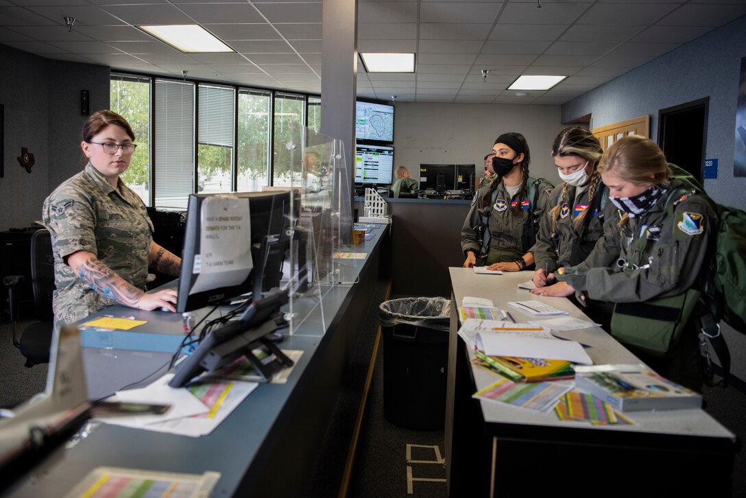 Airman 1st Class Cailey Brislin, 434th Squadron Aviation Resource Manager, finalizes flight plans for the all-female pilots flying in observance of Woman’s Equality Day at Laughlin Air Force Base, Texas, Aug. 26, 2020. Laughlin observes Women’s Equality Day by flying an all-female formation sortie with instructor and student pilots. (U.S. Air Force photo by Senior Airman Marco A. Gomez