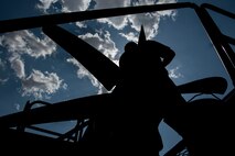 A photo of an Airman performing maintenance on an HC-130J