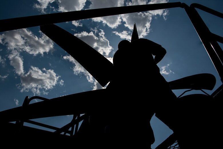 A photo of an Airman performing maintenance on an HC-130J