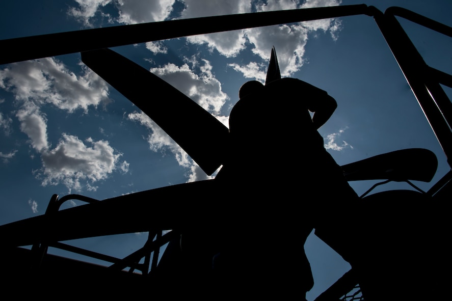 A photo of an Airman performing maintenance on an HC-130J