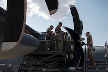 A photo of an Airman performing maintenance on an HC-130J