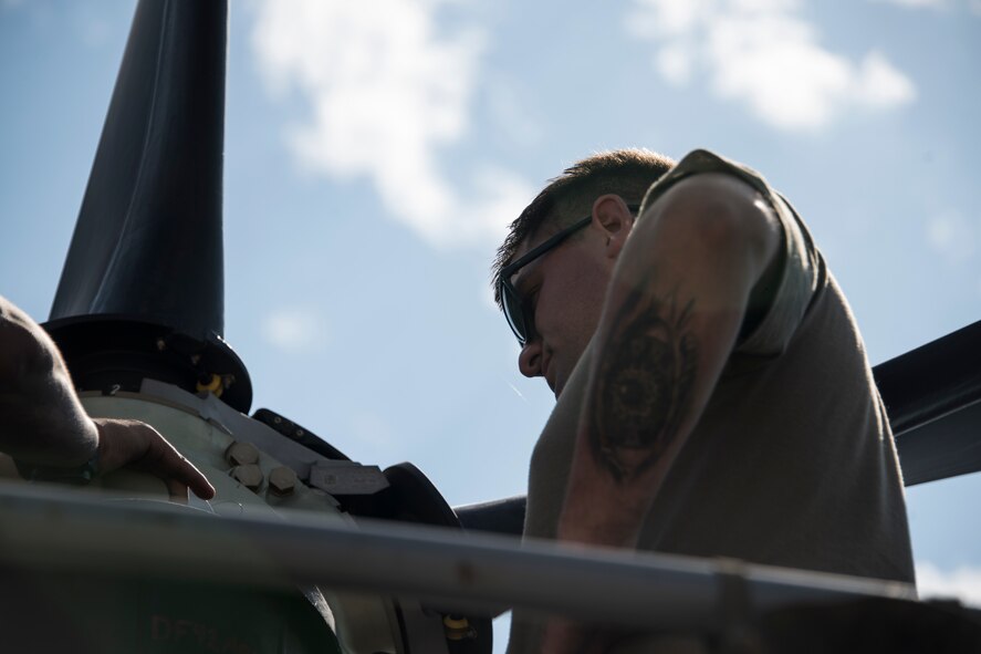 A photo of an Airman performing maintenance on an HC-130J