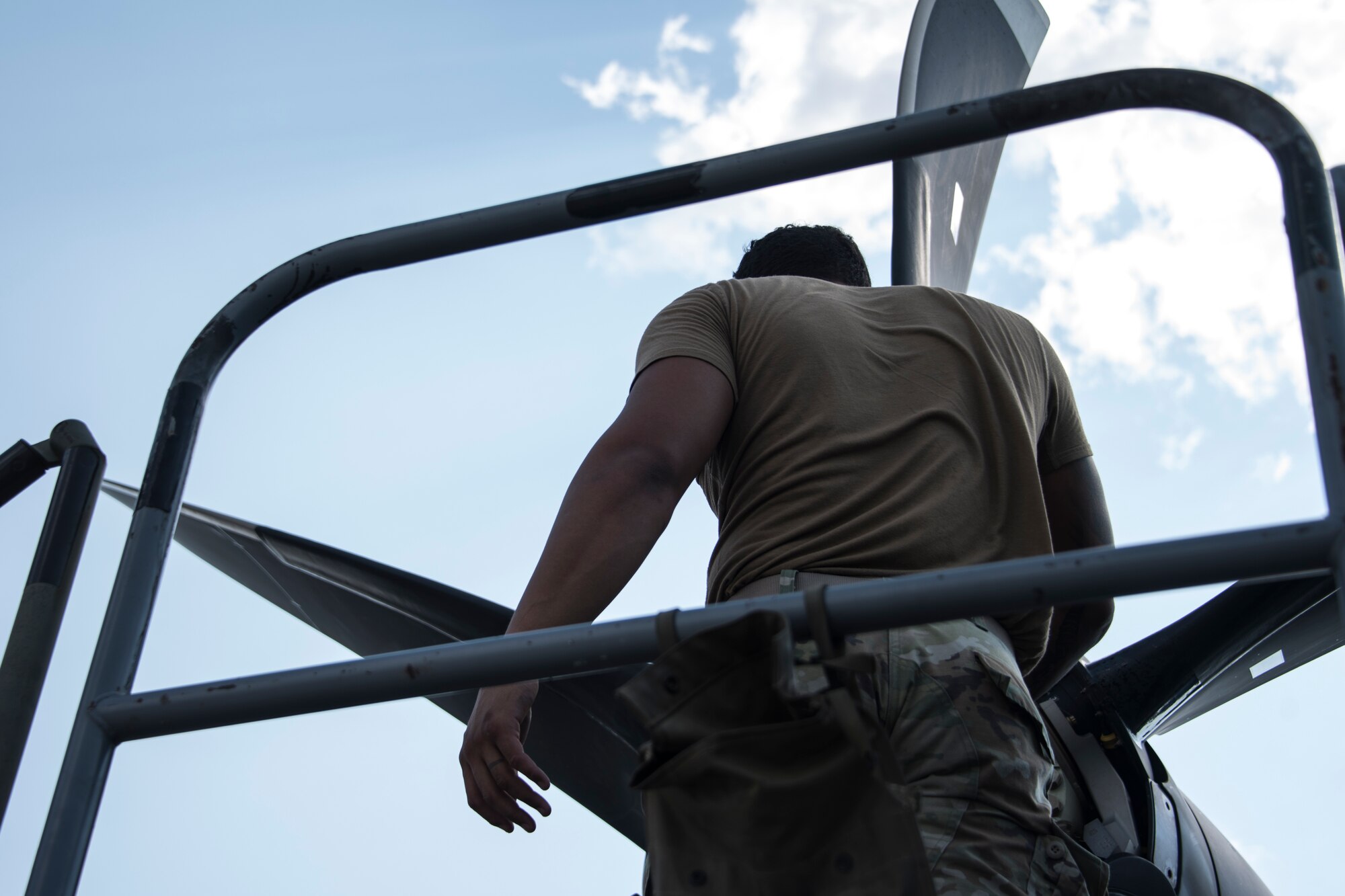 A photo of an Airman performing maintenance on an HC-130J