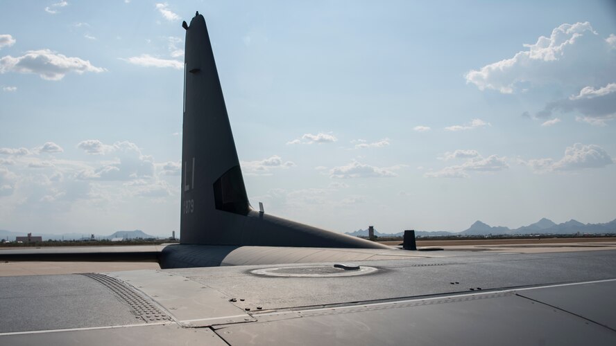 A photo of an Airman performing maintenance on an HC-130J