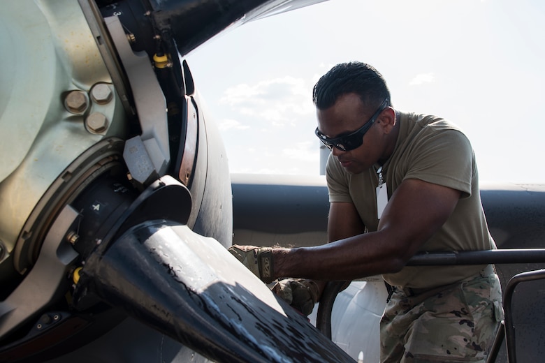 A photo of an Airman performing maintenance on an HC-130J