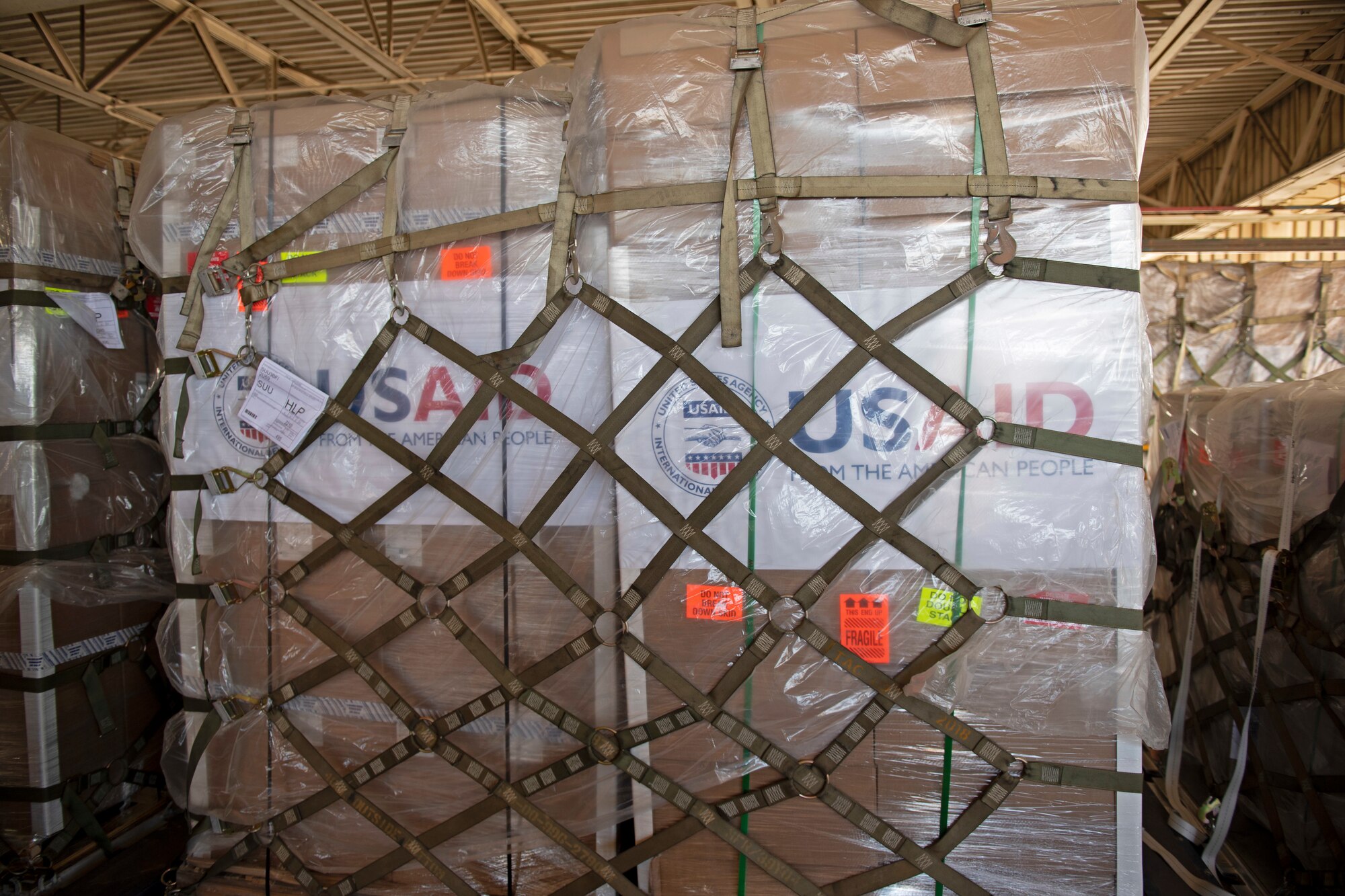 photos of aerial port airmen loading USAID of ventilators into a c-17 globemaster III.