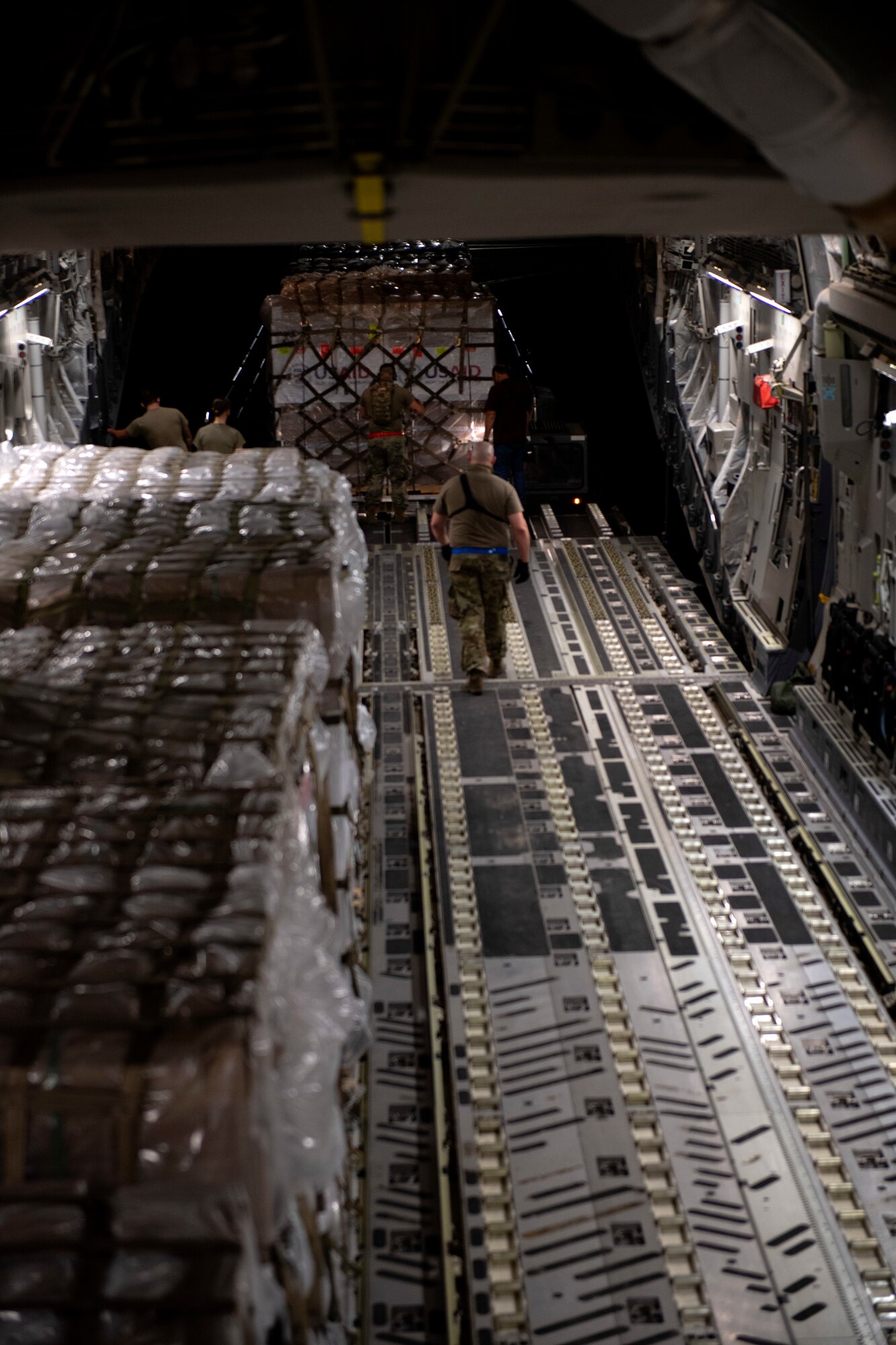 photos of aerial port airmen loading USAID of ventilators into a c-17 globemaster III.