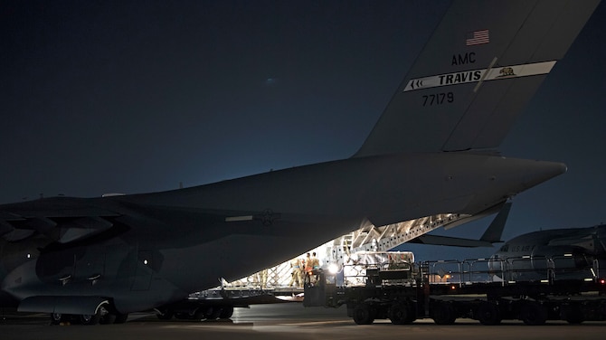 U.S. Air Force Maj. Roger Gates, 21st Airlift Squadron instructor pilot and assistant directive officer, describes a United States Agency for International Development mission Aug. 27, 2020, in a C-17 Globemaster III at Travis Air Force Base, California. Gates has served in the U.S. Air Force for 10 years and is a native of Georgia. (U.S. Air Force photo by Senior Airman Jonathon Carnell)
