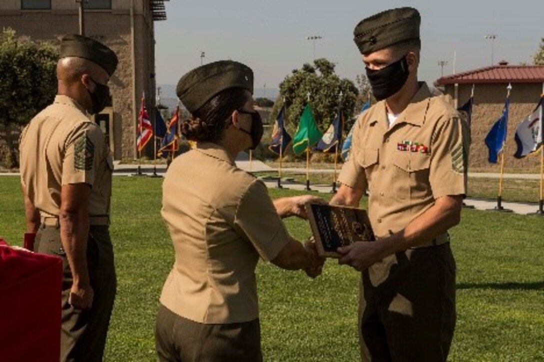 U.S. Marine Corps Staff Sgt. Andrew J. Collins, expeditionary contracting specialist, Expeditionary Contracting Platoon, Combat Logistics Regiment 17, 1st Marine Logistics Group, I Marine Expeditionary Force, is awarded the Expeditionary Contracting Professional of the Year award during an award ceremony at Marine Corps Base Camp Pendleton, California, Aug. 25, 2020.